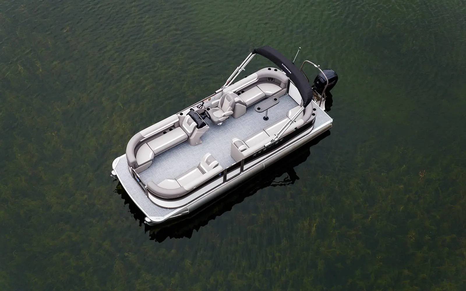 Aerial view of a pontoon floating over clear green water